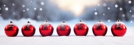 Row of red shiny Christmas balls on the snow. horizontal bannerの素材