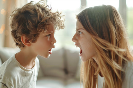 Mother and son having a loud argument shout at homeの素材