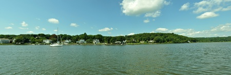 A panorama of a boat going across a lakeの写真素材