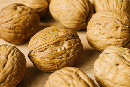 walnuts on wooden table closeup macro textureの写真素材