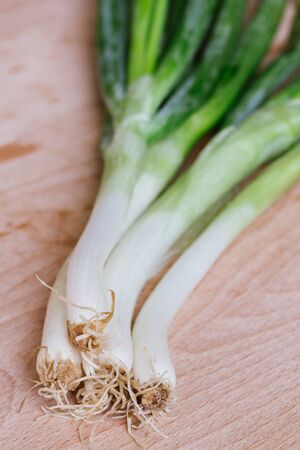 green spring onions on wooden backgroundの写真素材