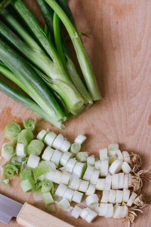 green spring onions on wooden backgroundの写真素材