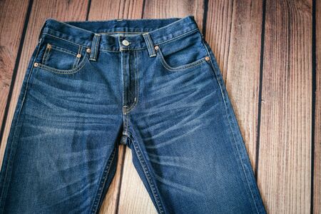 blue jeans on wooden backgroundの写真素材