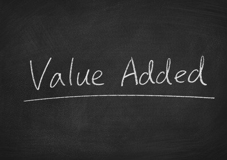 value added concept words on a blackboard backgroundの写真素材