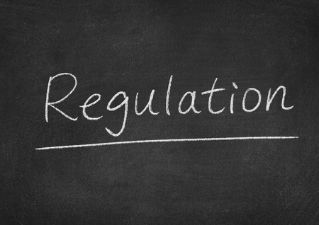 regulation concept word on a blackboard backgroundの写真素材