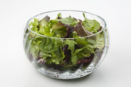 Mixed salad leaves in a glass bowlの写真素材