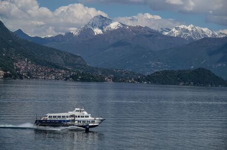 Lake Como in Italy beautiful scenery surrounded by snow capped mountains and lush Forrest.のeditorial素材