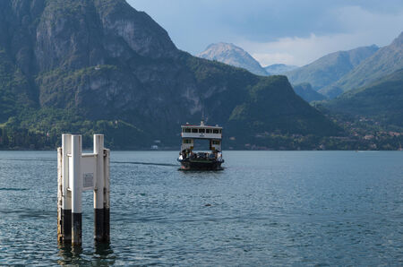 Lake Como in Italy beautiful scenery surrounded by snow capped mountains and lush Forrest.のeditorial素材