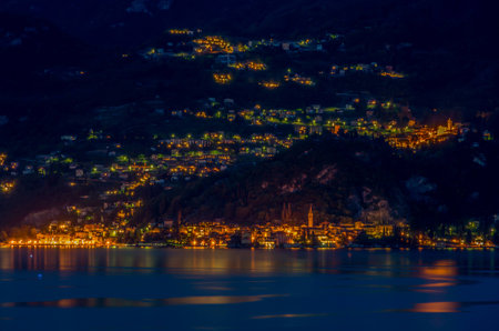 Lake Como in Italy beautiful scenery surrounded by snow capped mountains and lush Forrest.の写真素材