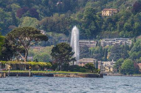 Lake Como in Italy beautiful scenery surrounded by snow capped mountains and lush Forrest.の写真素材