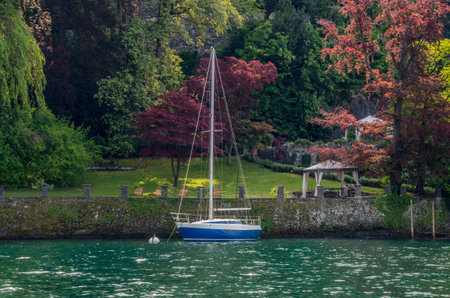 Lake Como in Italy beautiful scenery surrounded by snow capped mountains and lush Forrest.の写真素材