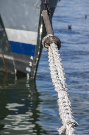 Head Line or Hawser of a moored boat tied up to a pier in Cape Town's  Table Bay Harbour