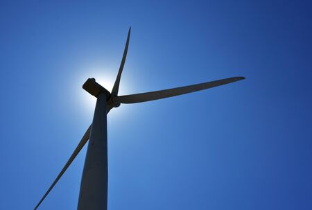 silhoutte of a windmill against the midday sunの写真素材