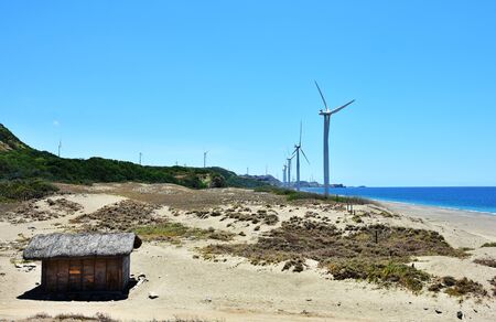 Giant windmills along seashoreの写真素材