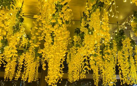 Yellow flowers with lighted ceiling decorationの写真素材