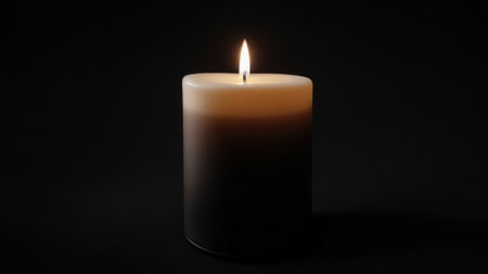 Burning candle on a black background. Close-up image.の素材