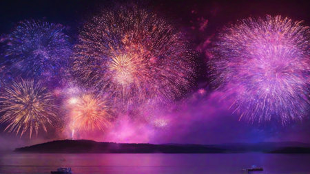 Colorful fireworks of various colors over the sea and night sky backgroundの素材
