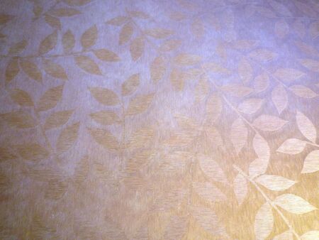 leaves in repeated design on a golden backgroundの写真素材