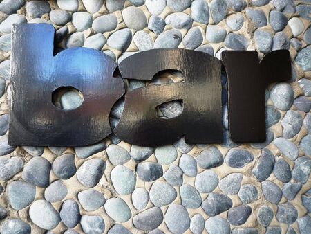 Bar sign with stone wall backgroundの写真素材