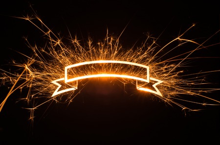 Sparkly glowing ribbon banner with copy space on dark background.の写真素材