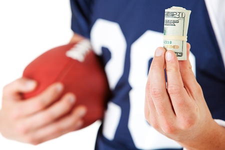 Caucasian American football player, in uniform, isolated on white, with various related props.の写真素材