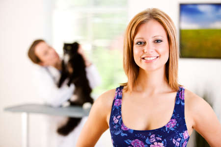 Series set in a Veterinarian's office, with a dog, cat, rabbit and a Caucasian veterinarian and customer.の写真素材