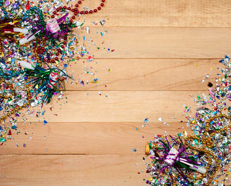 Background series good for New Year's Eve - with confetti, champagne, etc. and lots of copyspace on a wooden table setting.の写真素材