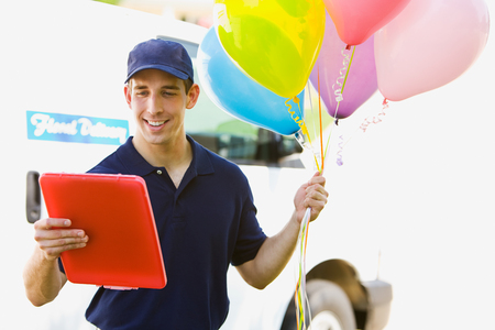Delivery: Man Taking Balloons to Houseの写真素材