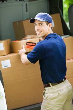 Delivery: Man Pulling Box from Delivery Vanの写真素材
