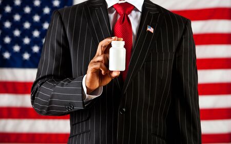 Politician: Holding a Blank Medicine Bottleの写真素材