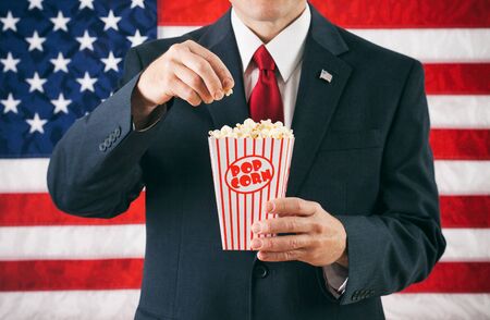Politician: Man Eating From Box Of Popcornの写真素材