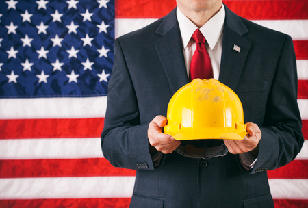 Politician: Man Holding Up Yellow Hard Hatの写真素材