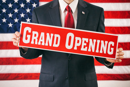 Politician: Man Holding Up Grand Opening Sign