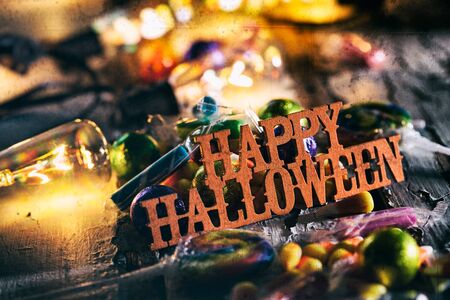 Halloween: Happy Halloween With Candy And Glowing Bulbsの写真素材