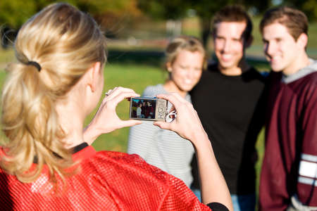 Football: Girl Takes Photo of Friendsの写真素材