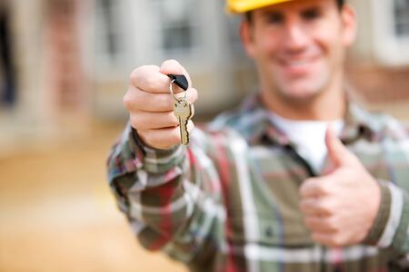 Series at a new home construction site.  Includes construction worker/builder, real estate agents and young Caucasian coupleの写真素材