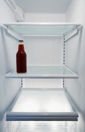 Refrigerator with bottle of soda.の写真素材