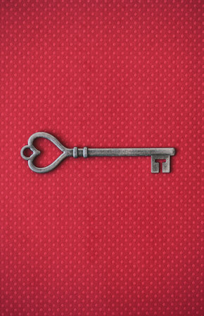 Old metal key with heart shaped end.