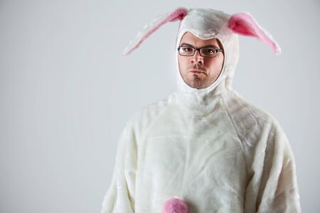 Isolated on white humorous series of a man in a fuzzy bunny suit.  Good for Easter or ironic situations.の写真素材