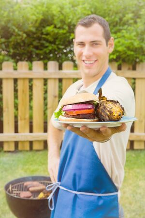 Series of an expressive man in the backyard, doing some grilling.の写真素材