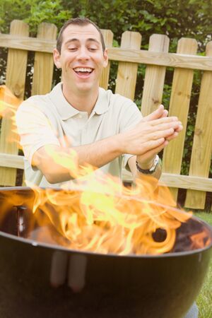 Series of an expressive man in the backyard, doing some grilling.の写真素材