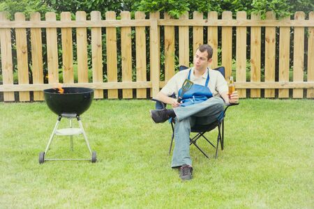 Series of an expressive man in the backyard, doing some grilling.の写真素材