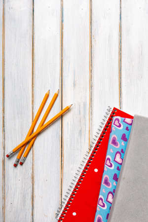 Series on weathered wood background with school items, as well as face masks and hand sanitizer for back to school.の写真素材