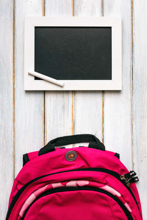 Series on weathered wood background with school items, as well as face masks and hand sanitizer for back to school.の写真素材