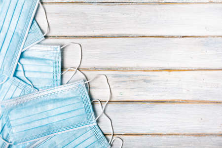 Series on weathered wood background with school items, as well as face masks and hand sanitizer for back to school.の写真素材