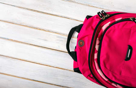 Series on weathered wood background with school items, as well as face masks and hand sanitizer for back to school.の写真素材