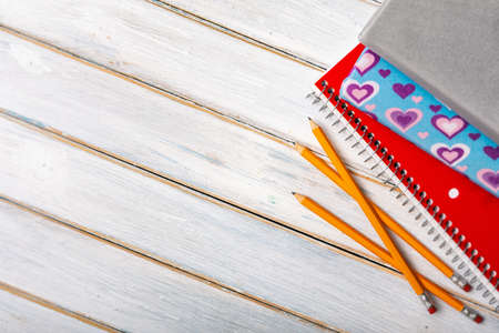 Series on weathered wood background with school items, as well as face masks and hand sanitizer for back to school.の写真素材
