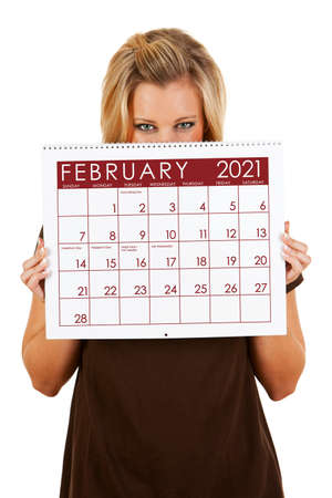 Cute series with a Caucasian woman holding a calendar for different times of the year.の写真素材