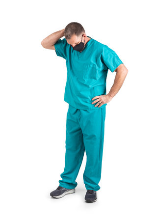 Male physician in scrubs and a mask, during the covid-19 pandemic.の写真素材