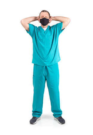 Male physician in scrubs and a mask, during the covid-19 pandemic.の写真素材